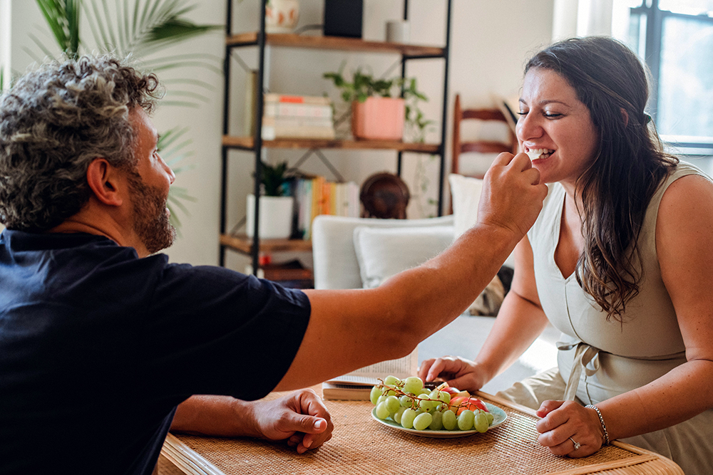 Taste It. Smiling beautiful girl with her date, enjoying a  healthy vegan meal together